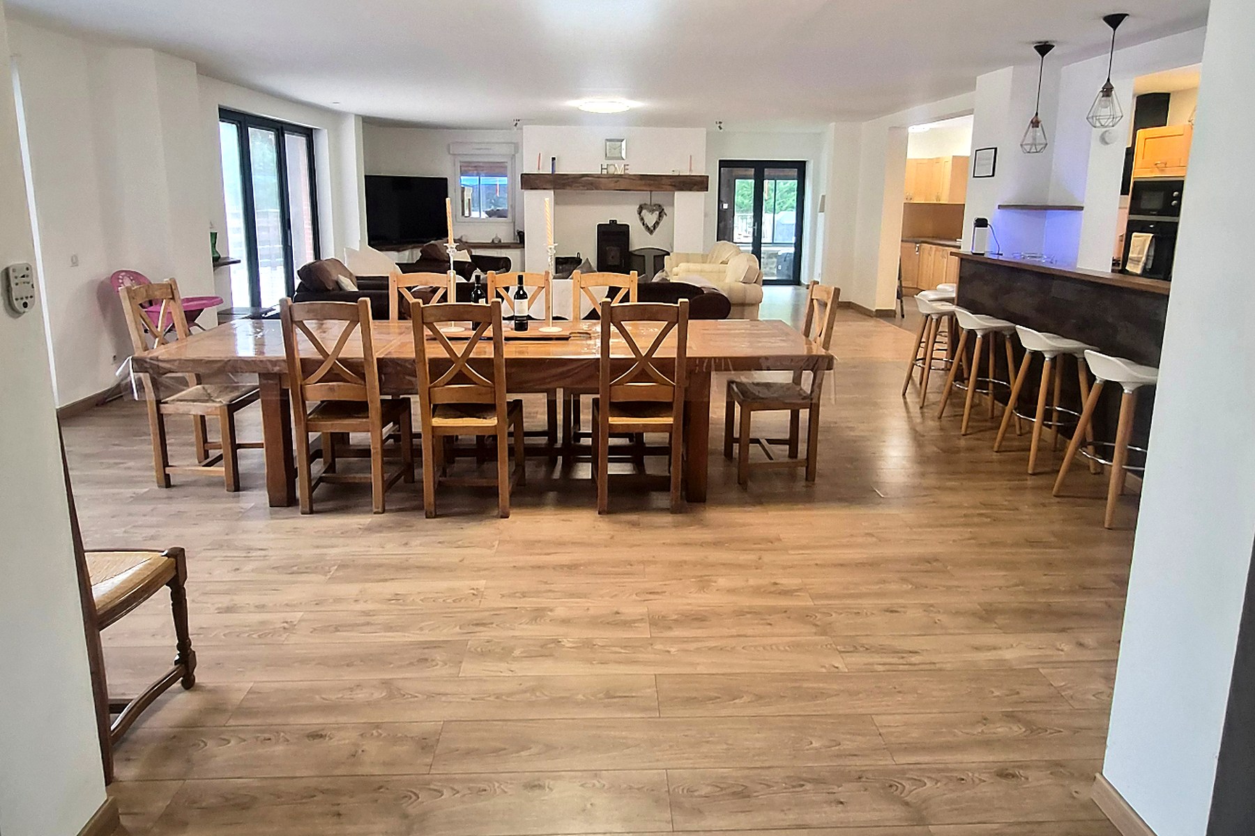 Long oak dining table with wooden chairs at Willowtree Gîtes
