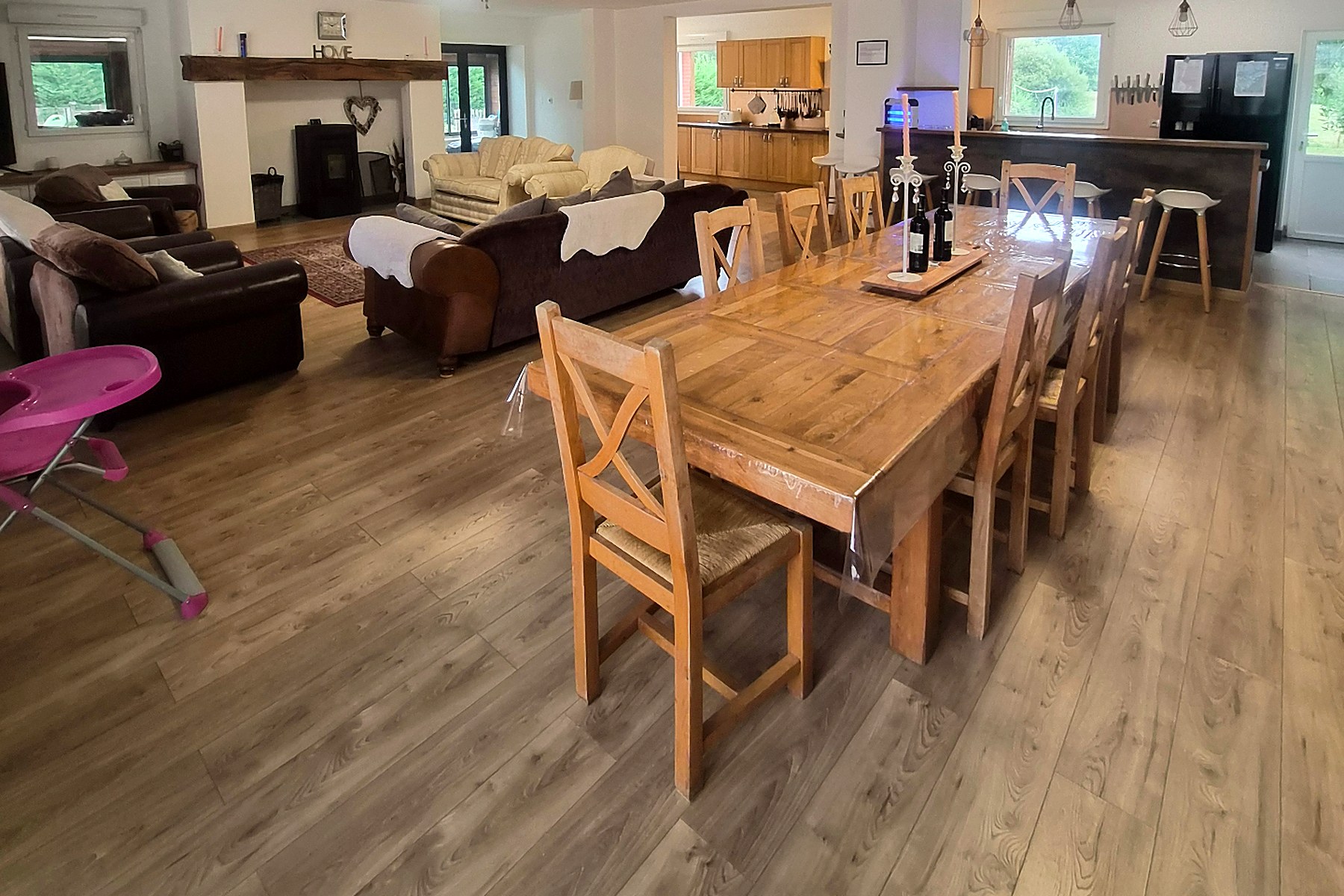 Oak dining table and wooden chairs beside the breakfast bar
